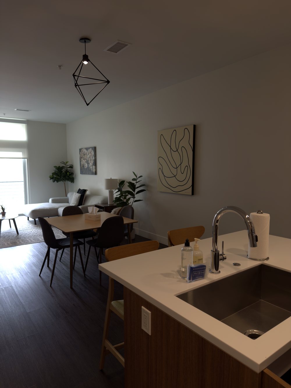 Spotless hospitality suite with kitchen and living area