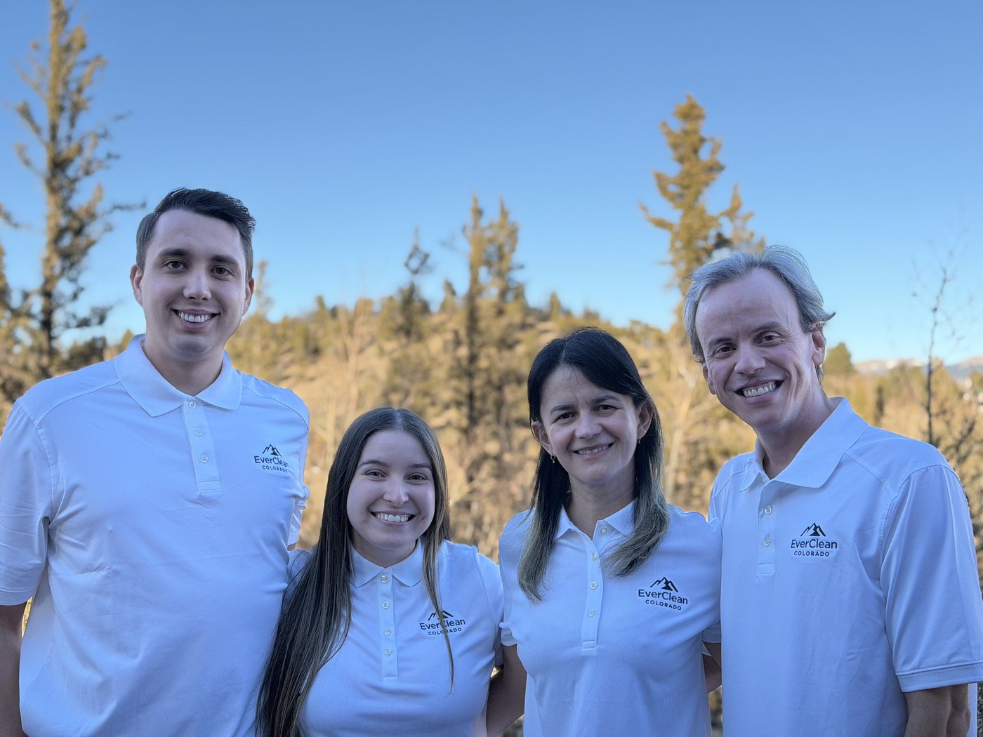 The EverClean team in uniform with the Colorado mountains behind them
